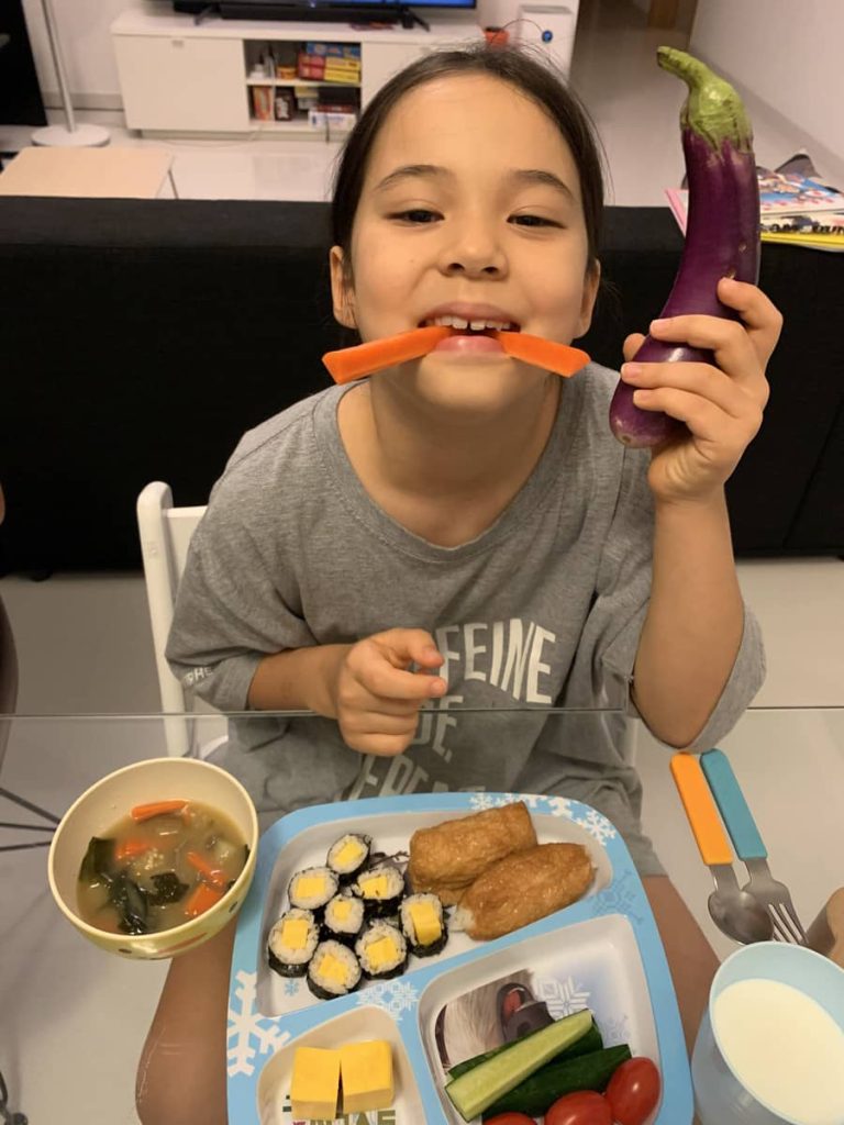 Miya presenting miso soup dish