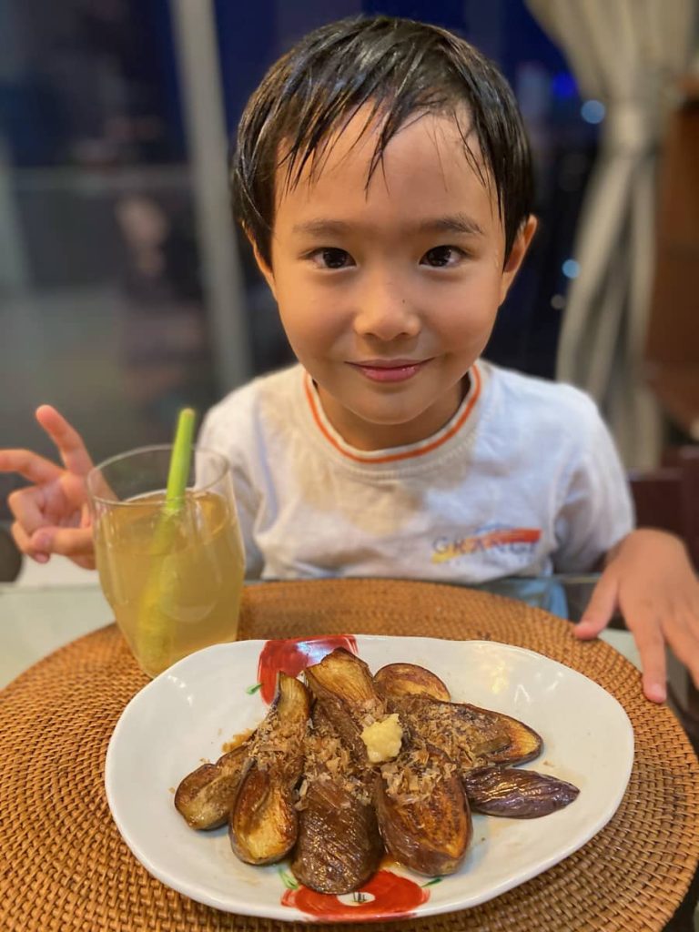 Shumpei presenting lemongrass eggplant dish creation