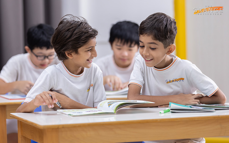 Two students studying together in a classroom.